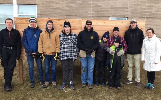 Sinacola, far right, students and community members pose in front of the compost bin in Alumni Arbor March 2019.