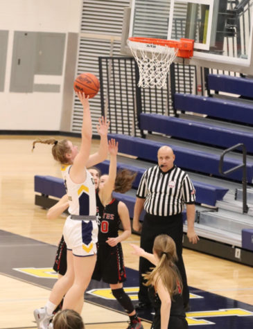 Air-Time. During the game against the Pinckney Pirates, senior Megan McCalla jumps in the air as she drives the ball to get the “And-1”.