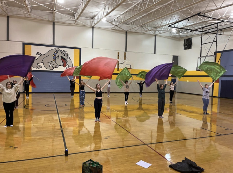 Woosh! Winter Guard members practice lots to get their moves in sync!