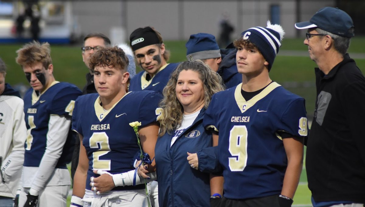Senior Running Back Thomas Shemwell (2) stands with his family and fellow teammate and brother Jonathan  Shemwell (9)
