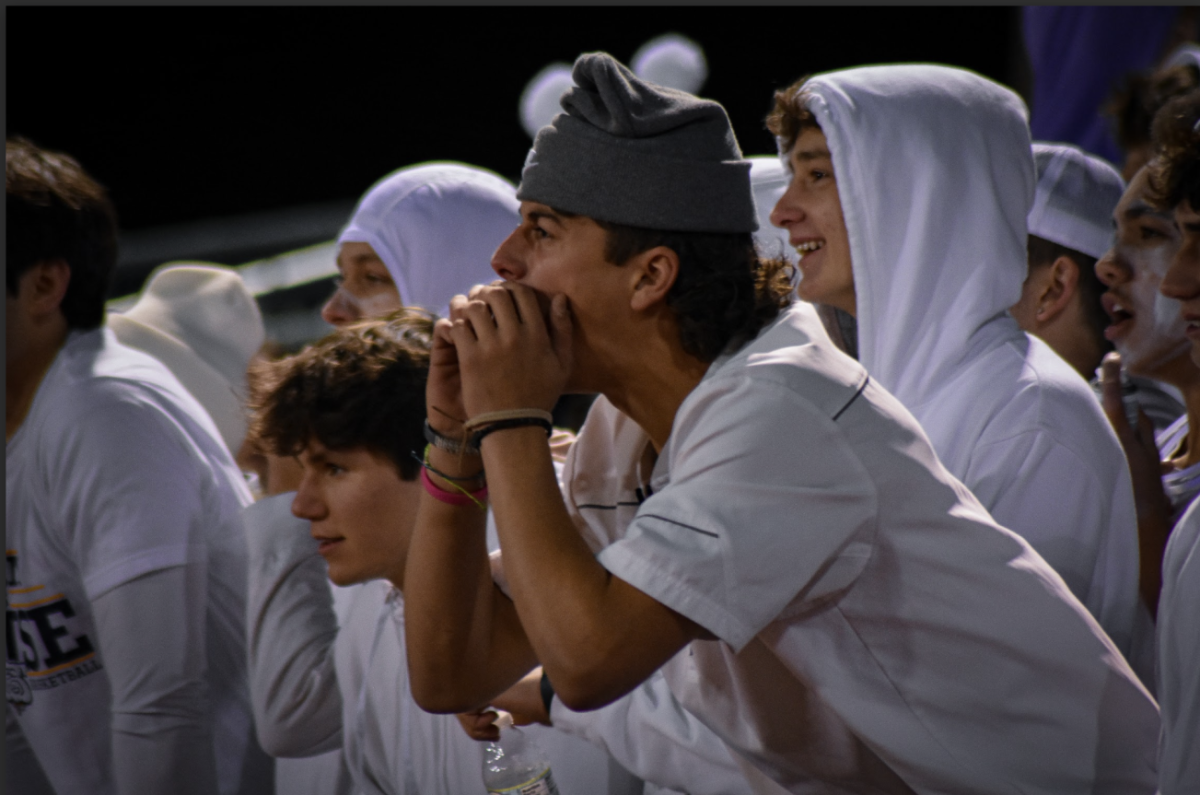 Senior Logan Eckhout passionately cheers for the Bulldogs during the rivalry game.
