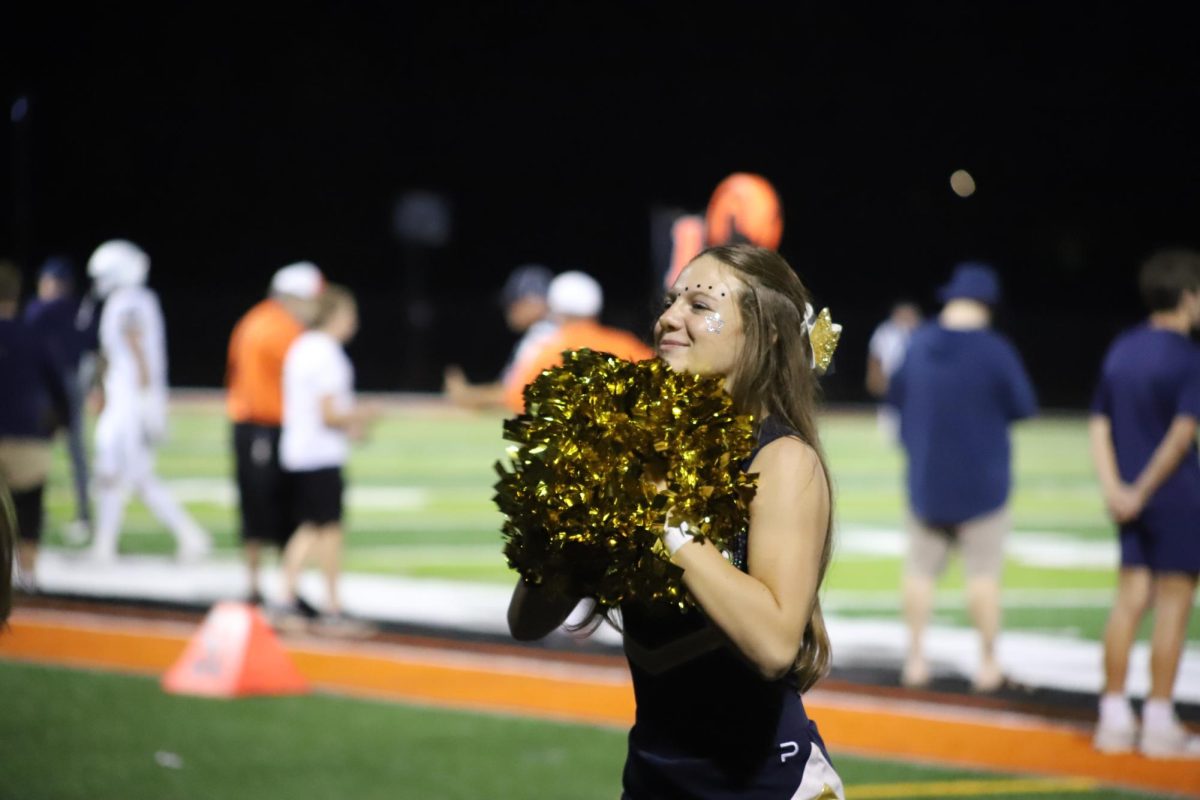 Freshman Allie Ferguson enjoying cheering on the sidelines of the game