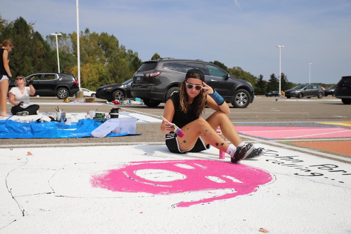 Izzy D'Alecy having fun painting her 'John Pork' parking spot