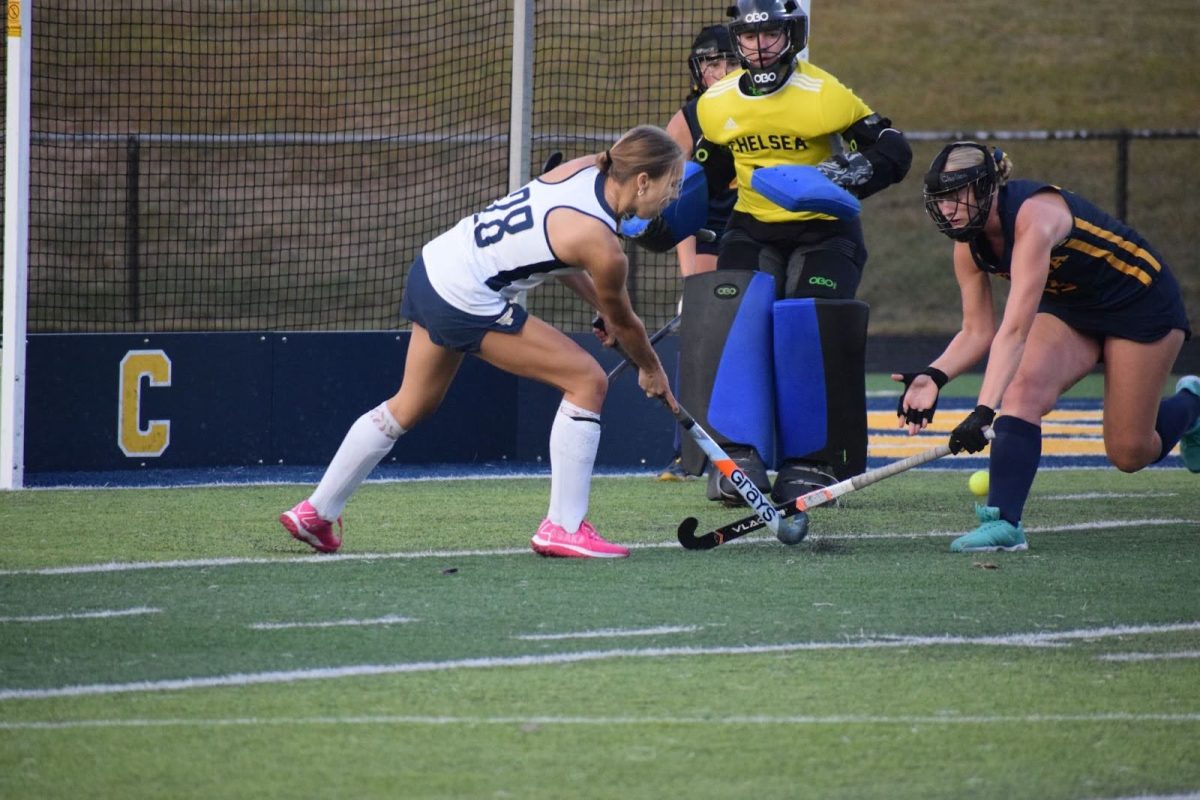 Rowan Burkel goes head on against South Lyon to protect the goal alongside their goalie